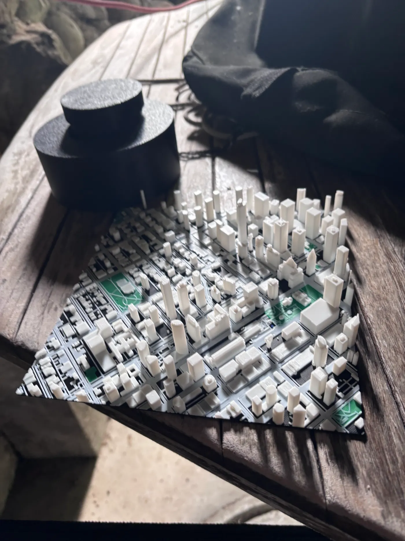 White 3D-printed skyscrapers of downtown Vancouver on a grey street grid with green parks